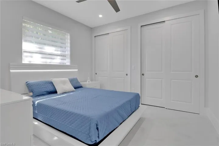 Bedroom with two closets and ceiling fan