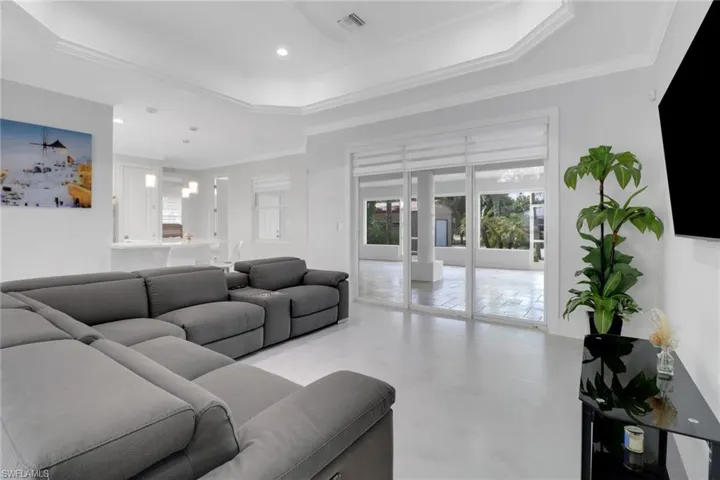 Living room with crown molding and a raised ceiling