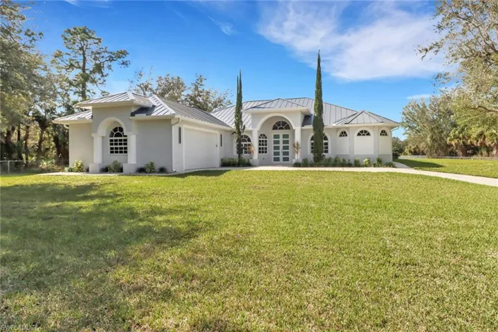 Mediterranean / spanish home with a front lawn