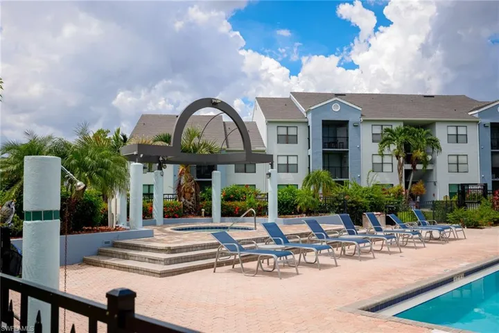 View of swimming pool featuring a patio and a hot tub