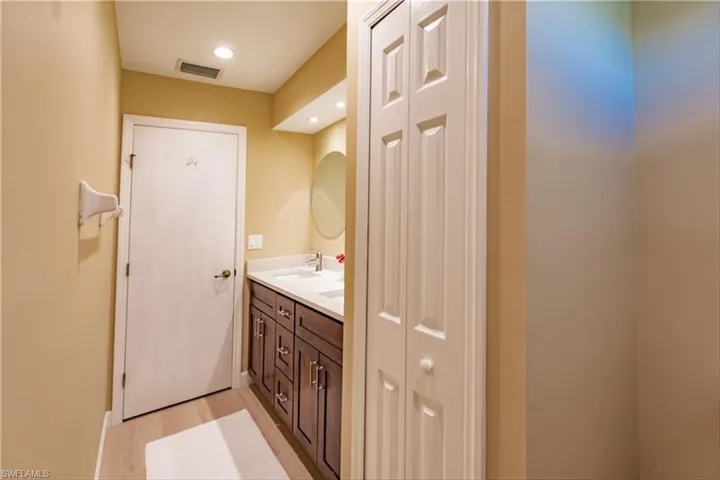 Bathroom with hardwood / wood-style floors and vanity