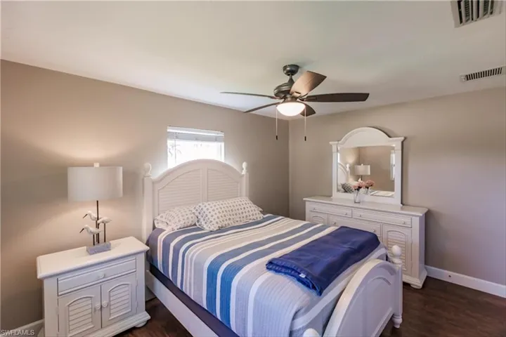 Bedroom featuring dark hardwood / wood-style floors and ceiling fan