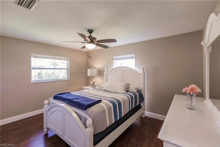 Bedroom featuring dark hardwood / wood-style flooring and ceiling fan