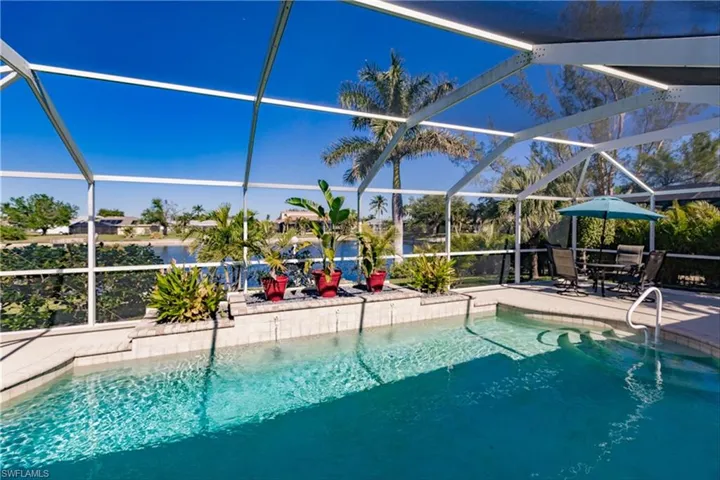 View of swimming pool featuring a lanai and a patio area