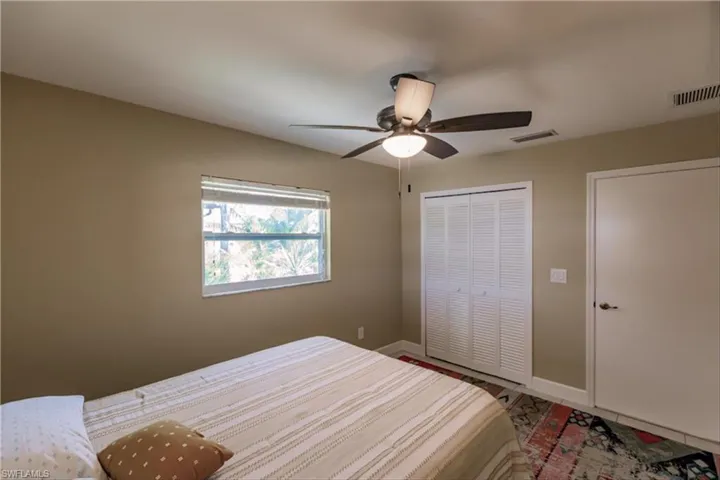 Bedroom with ceiling fan and a closet