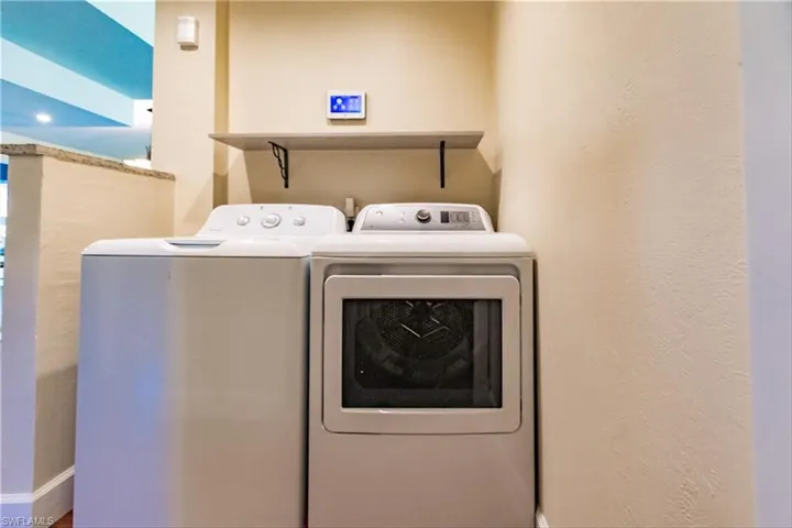 Clothes washing area featuring separate washer and dryer