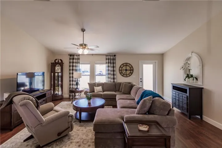 Living room featuring ceiling fan and hardwood / wood-style flooring
