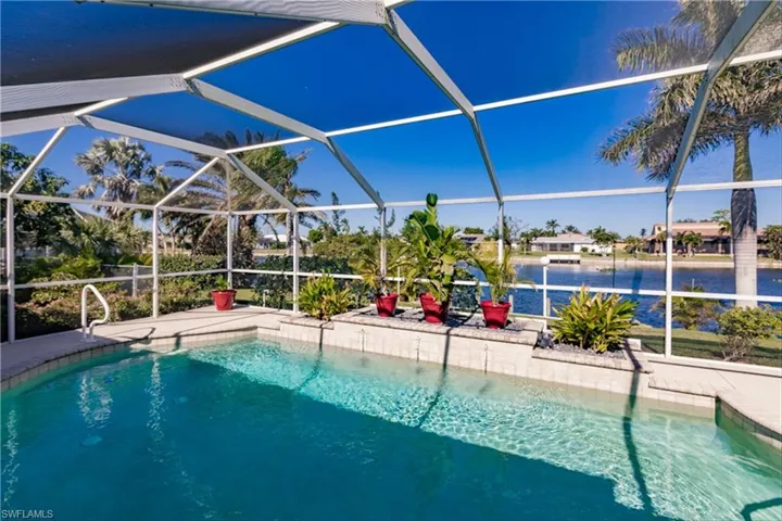 View of pool featuring a lanai and a water view