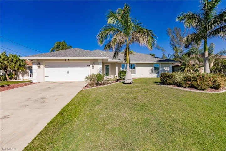 Ranch-style house with a garage and a front yard