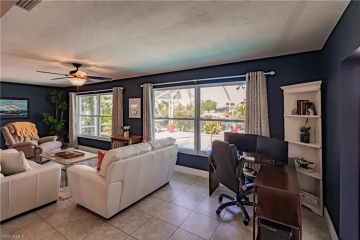 Living room featuring ceiling fan and light tile patterned flooring