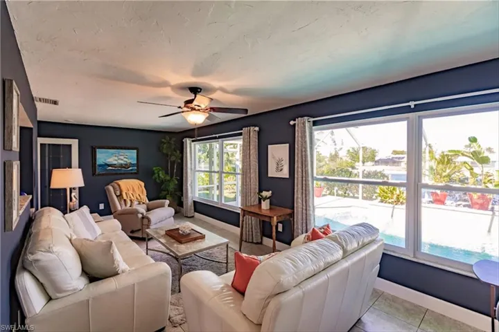 Living room featuring ceiling fan and light tile patterned flooring