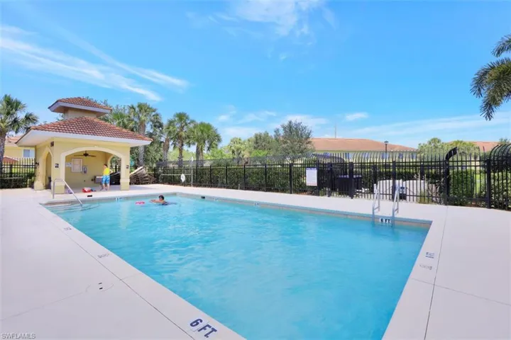 Pool featuring a patio, fence, and ceiling fan