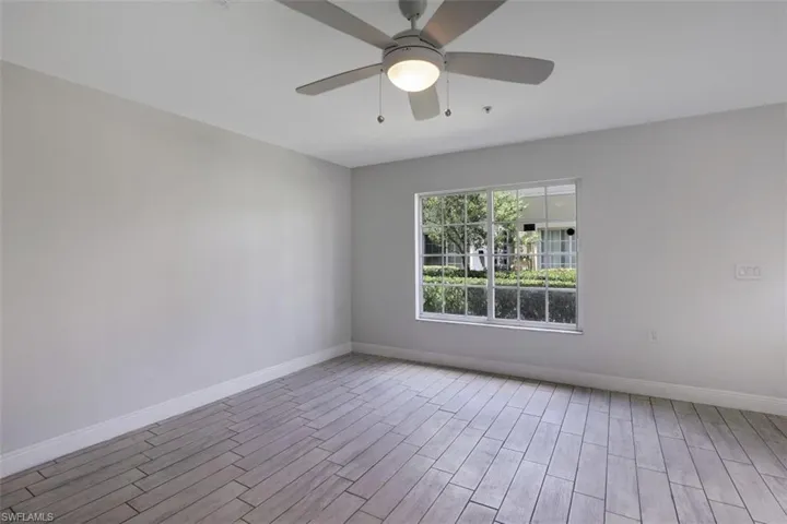 Empty room with baseboards, ceiling fan, and wood finished floors