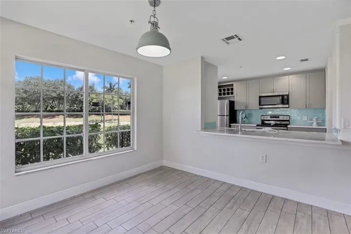 Kitchen featuring visible vents, backsplash, light countertops, and appliances with stainless steel finishes