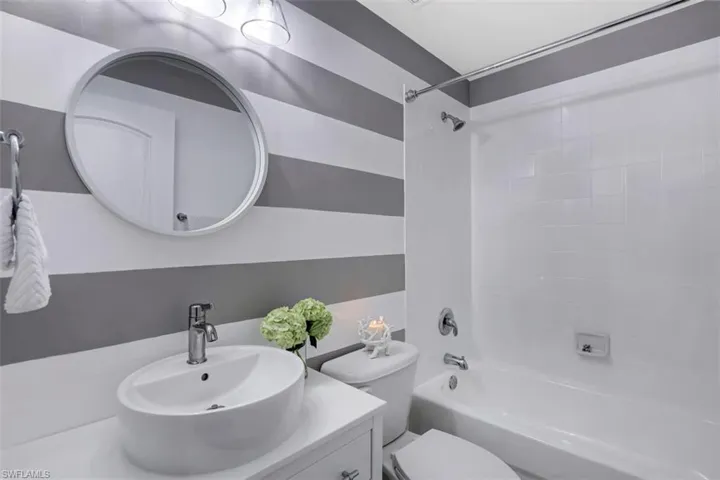 Full bath featuring toilet, vanity, and shower / bath combination