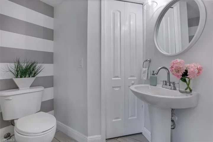 Half bathroom with baseboards and toilet