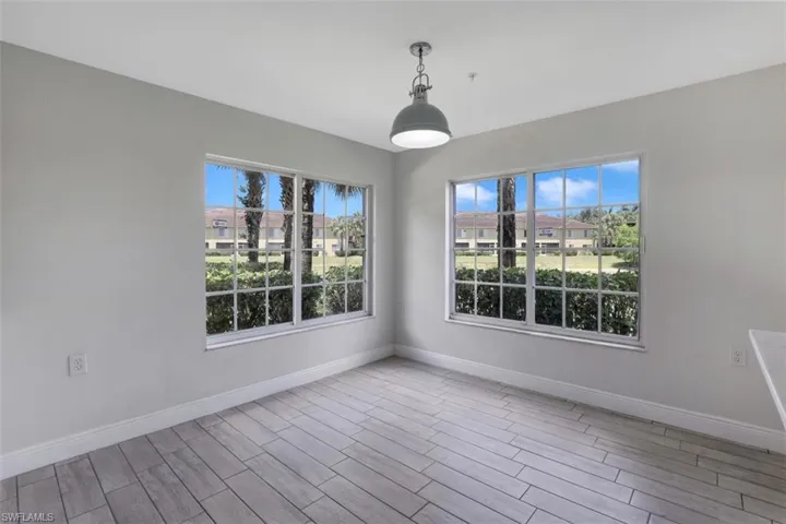 Empty room with baseboards and wood finished floors