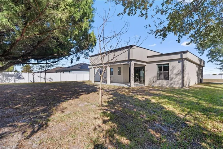 Back of house featuring a patio area and stucco siding