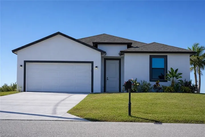 Contemporary stucco exterior with dark trim accents, a two-car garage, and established landscaping