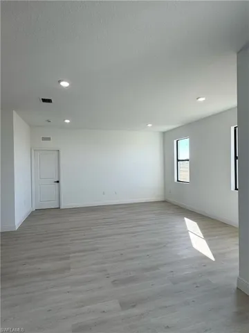 Spacious room with light wood-finish flooring