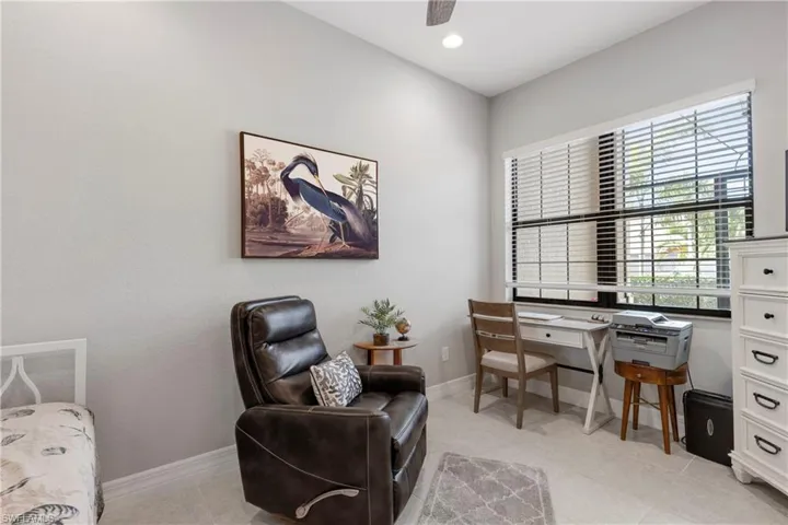 Office with ceiling fan and light tile patterned floors