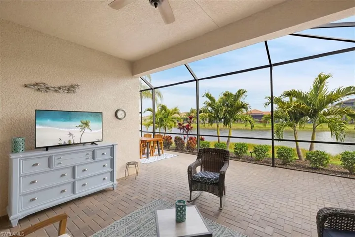 Sunroom featuring a water view and ceiling fan