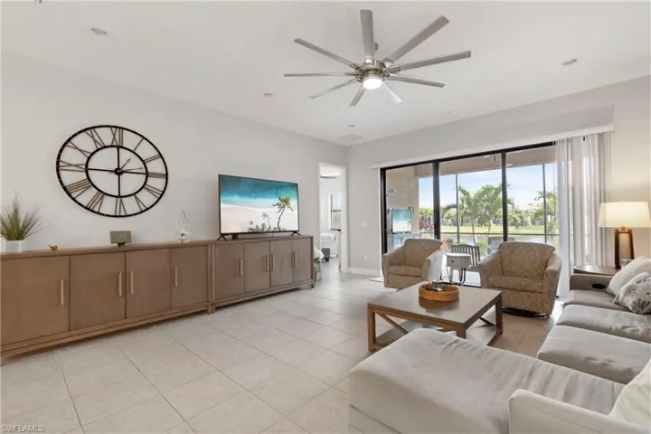 Tiled living room featuring ceiling fan