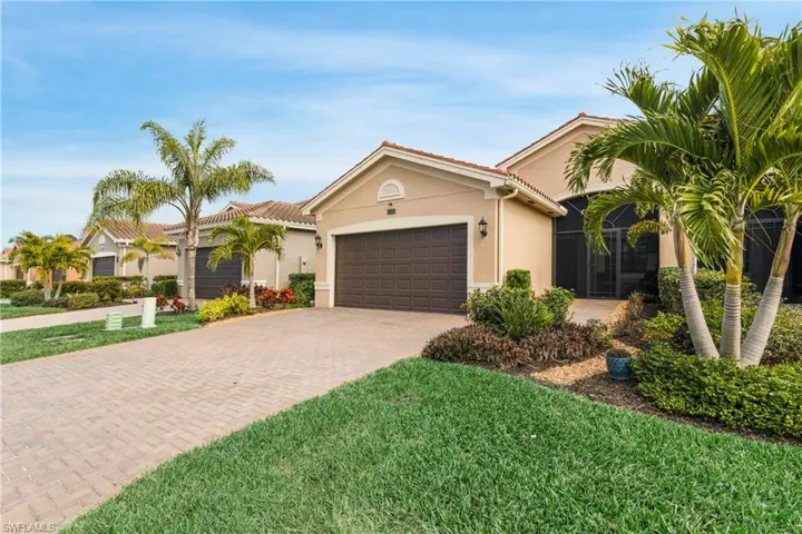 View of front of house with a garage and a front yard