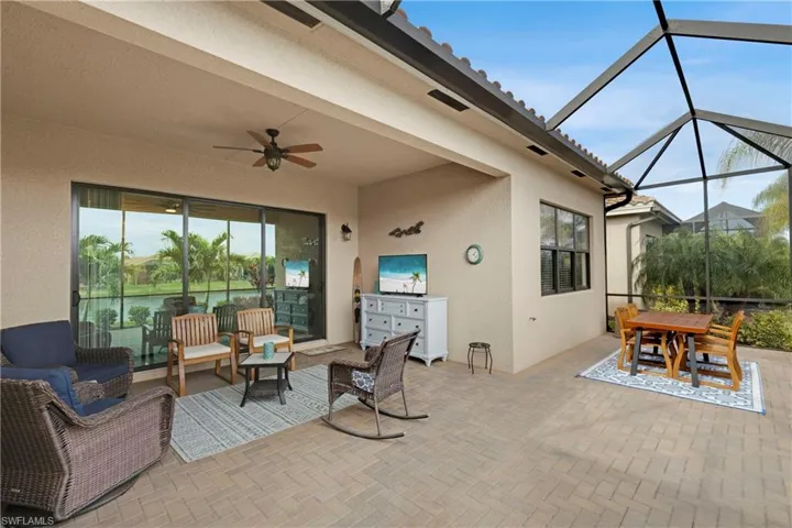 View of patio / terrace featuring an outdoor living space, ceiling fan, and glass enclosure