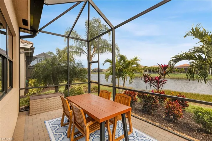 Sunroom / solarium featuring a water view