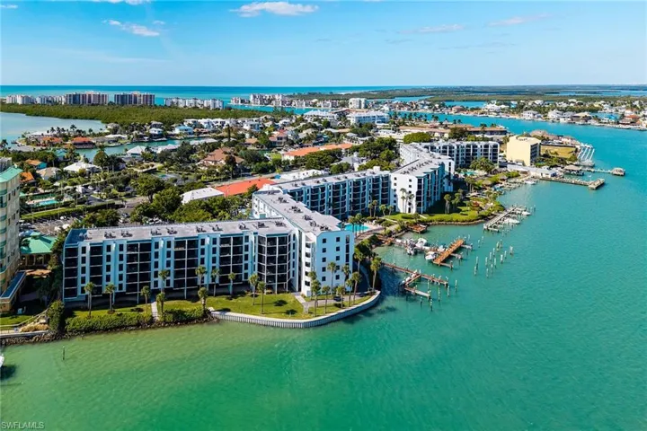 View of urban area with a large body of water and numerous boat docks