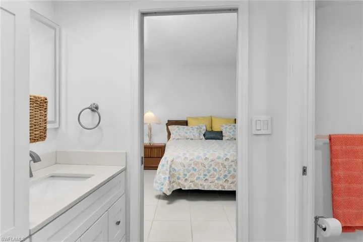 Bedroom with a sink and light tile patterned floors