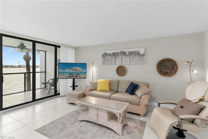 Living room featuring expansive windows and tile patterned flooring