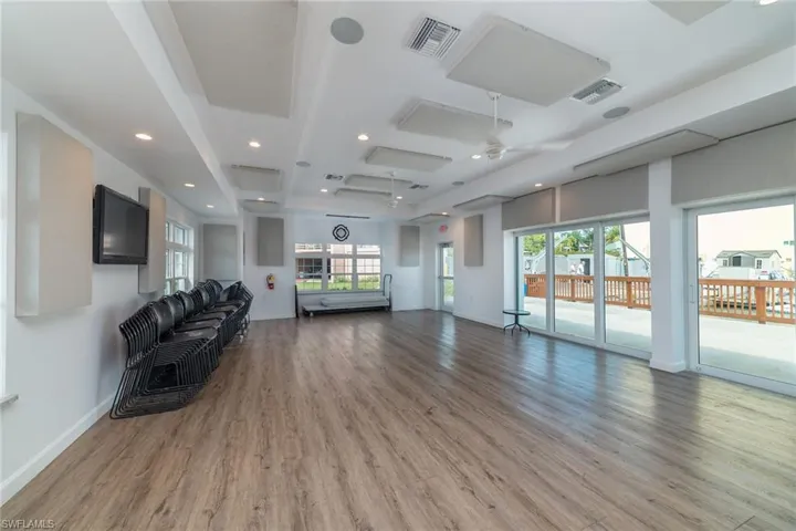 Living room with recessed lighting, light wood-style floors, and ceiling fan