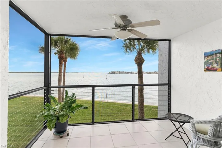 Unfurnished sunroom with a water view and plenty of natural light