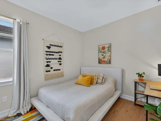 Comfortable guest bedroom with natural light and neutral tones.