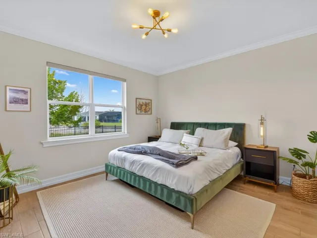 Elegant primary bedroom with abundant natural light and lake views.