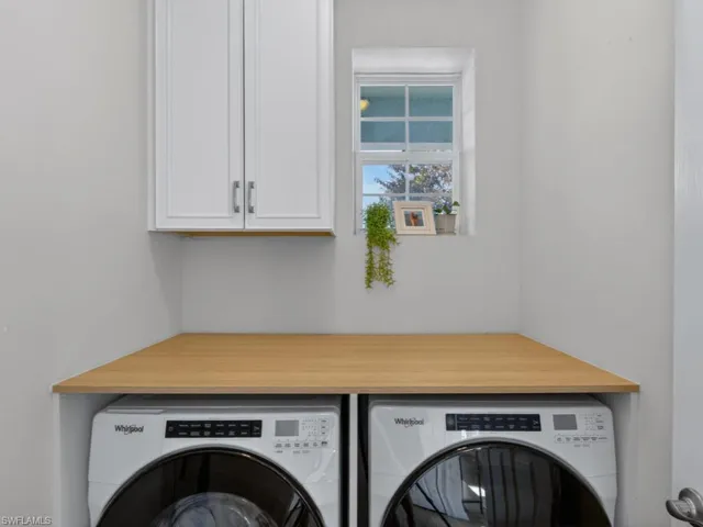 Convenient in home laundry room with extra storage and counter space.