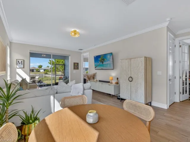 Open dining and living area overlooking the lanai and lake.