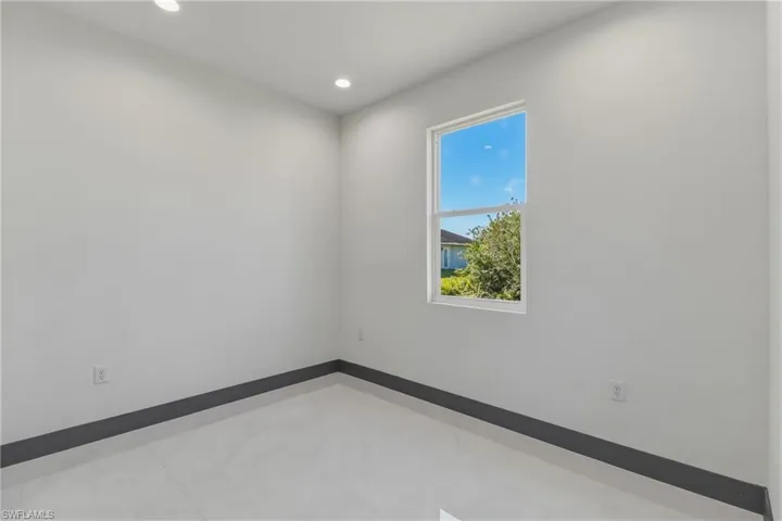 Spare room featuring recessed lighting and baseboards