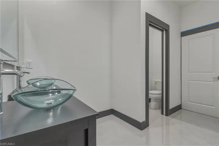Bathroom featuring toilet and double vanity