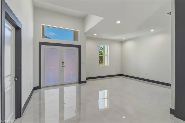 Entrance foyer featuring french doors, recessed lighting, and light tile patterned flooring