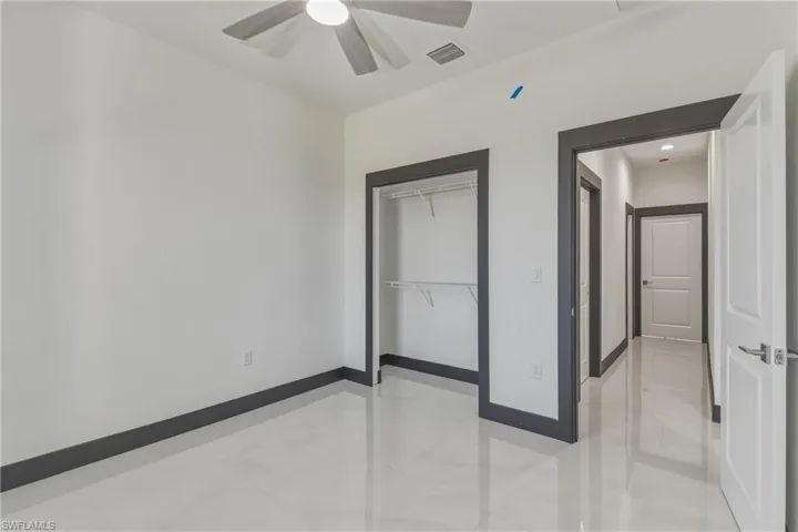 Unfurnished bedroom featuring a closet and ceiling fan
