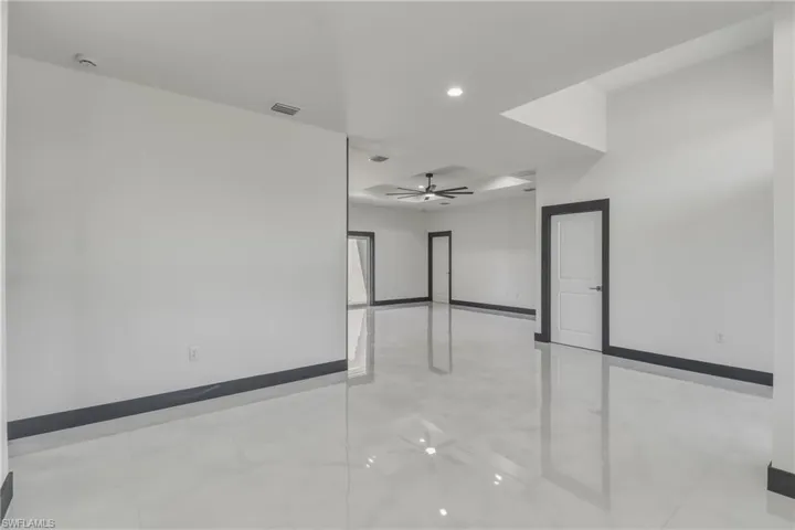 Empty room featuring ceiling fan and recessed lighting