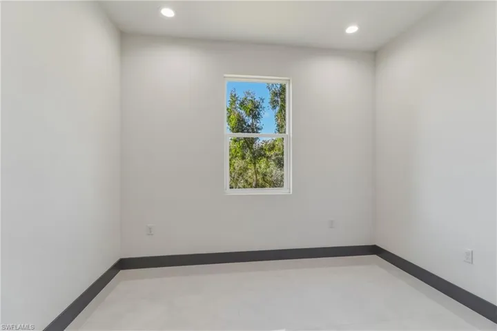 Spare room with recessed lighting and baseboards