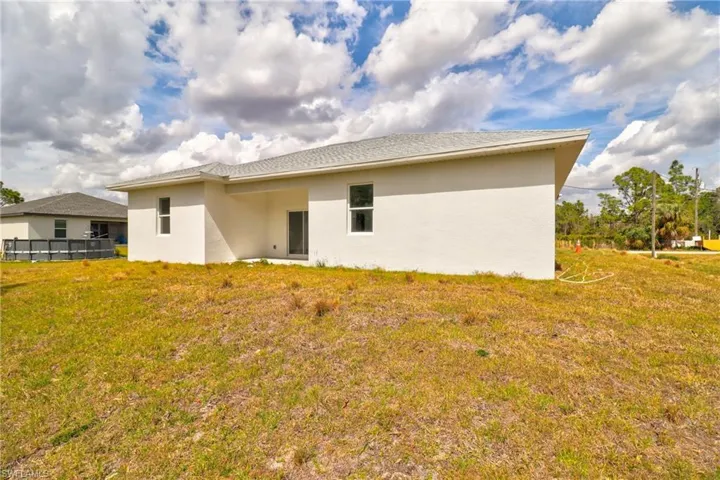 Rear view of property with stucco siding and a patio area