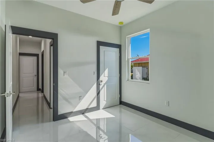 Spare room with baseboards and ceiling fan
