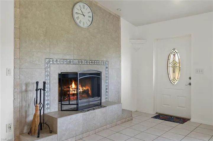Foyer featuring tile walls, tile floors, and a tile fireplace