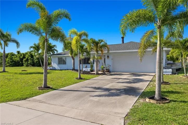 Single story home with a garage and a front yard