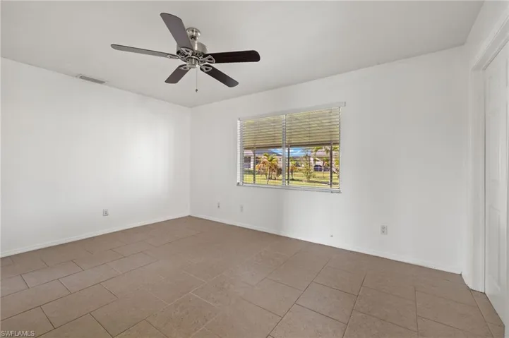Spare room with tile floors and ceiling fan